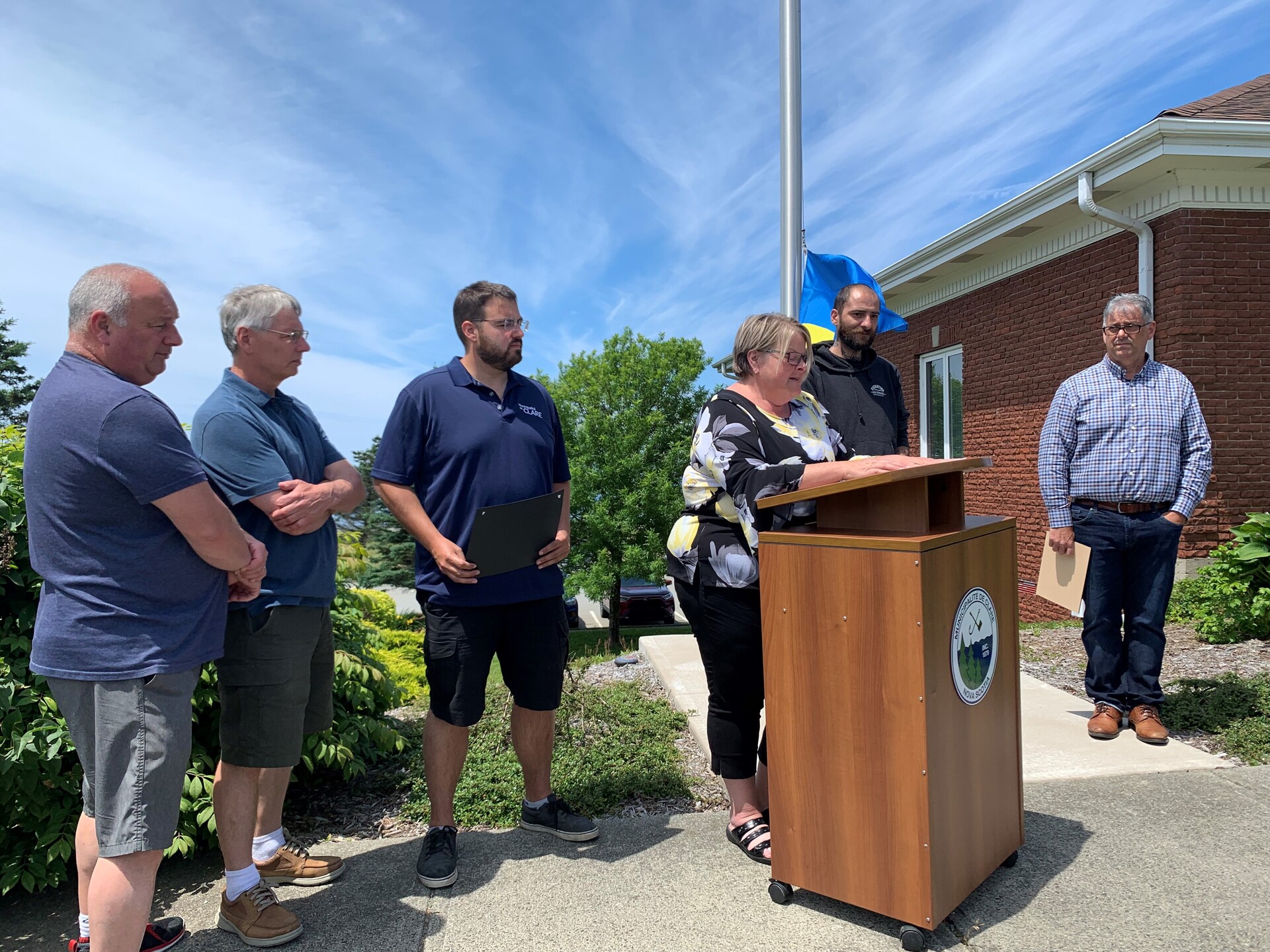 People standing around a podium