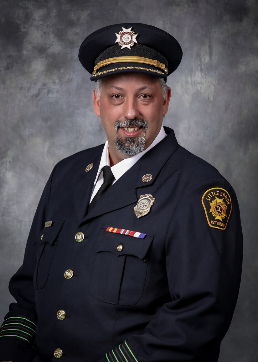 A picture of Yvon Thibodeau in his Fire Fighter suit. 